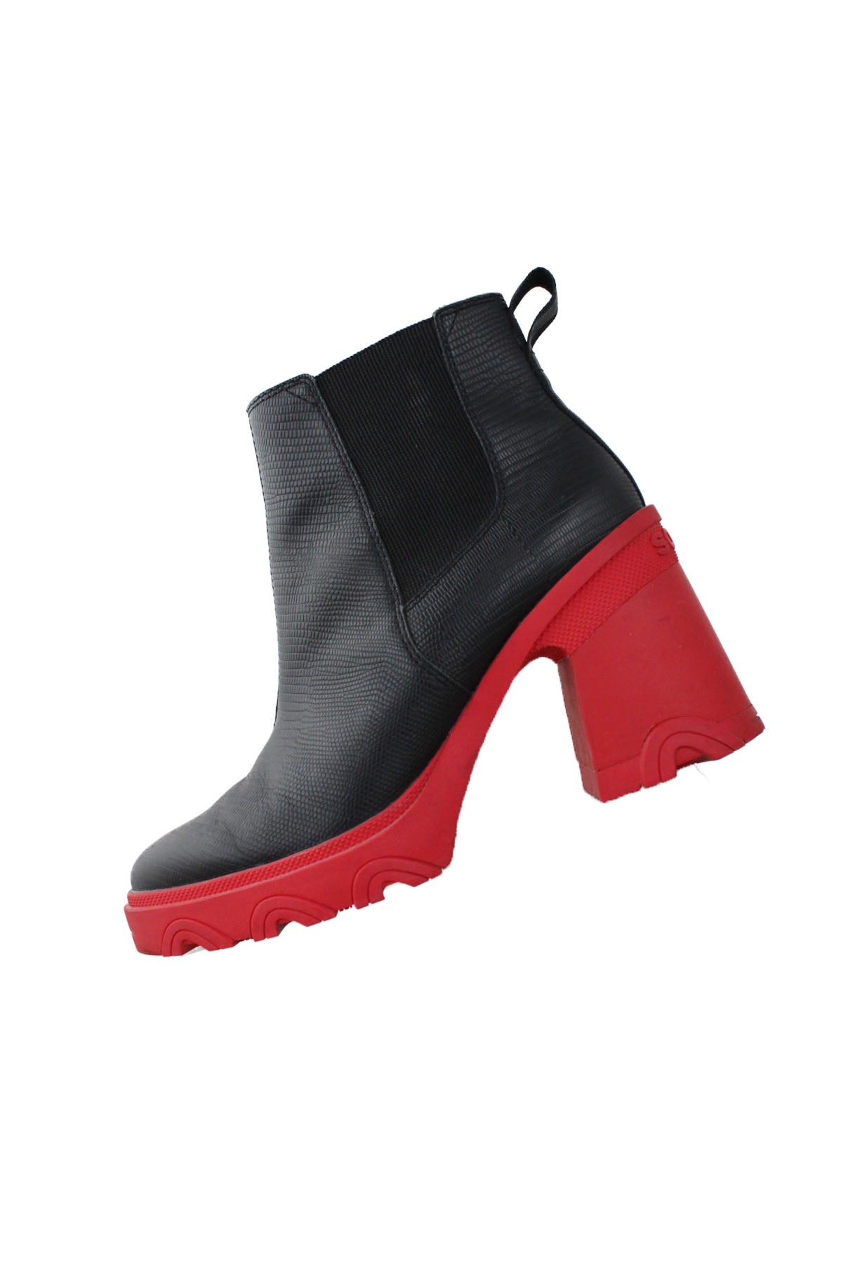 profile of sorel black and red chelsea ankle boots. features crocodile texture throughout, rounded toe, elastic at sides, red platform sole, and slip on fit. 