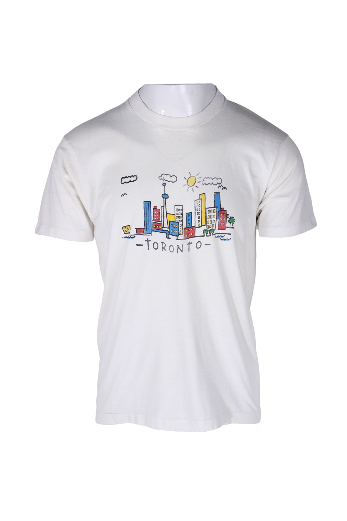front angle of short sleeve t-shirt on masc mannequin torso. features cartoon print of toronto skyline on a sunny day with text 'toronto' in childlike font. single stitch hem/cuffs. fabric is worn to soft semi-sheer state. 