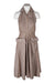 description: vintage natylnn light taupe halter silhouette dress. features collar, button closure at bodice top, oversize flap pockets at front, zipper closure at left side, and a-line skirt.