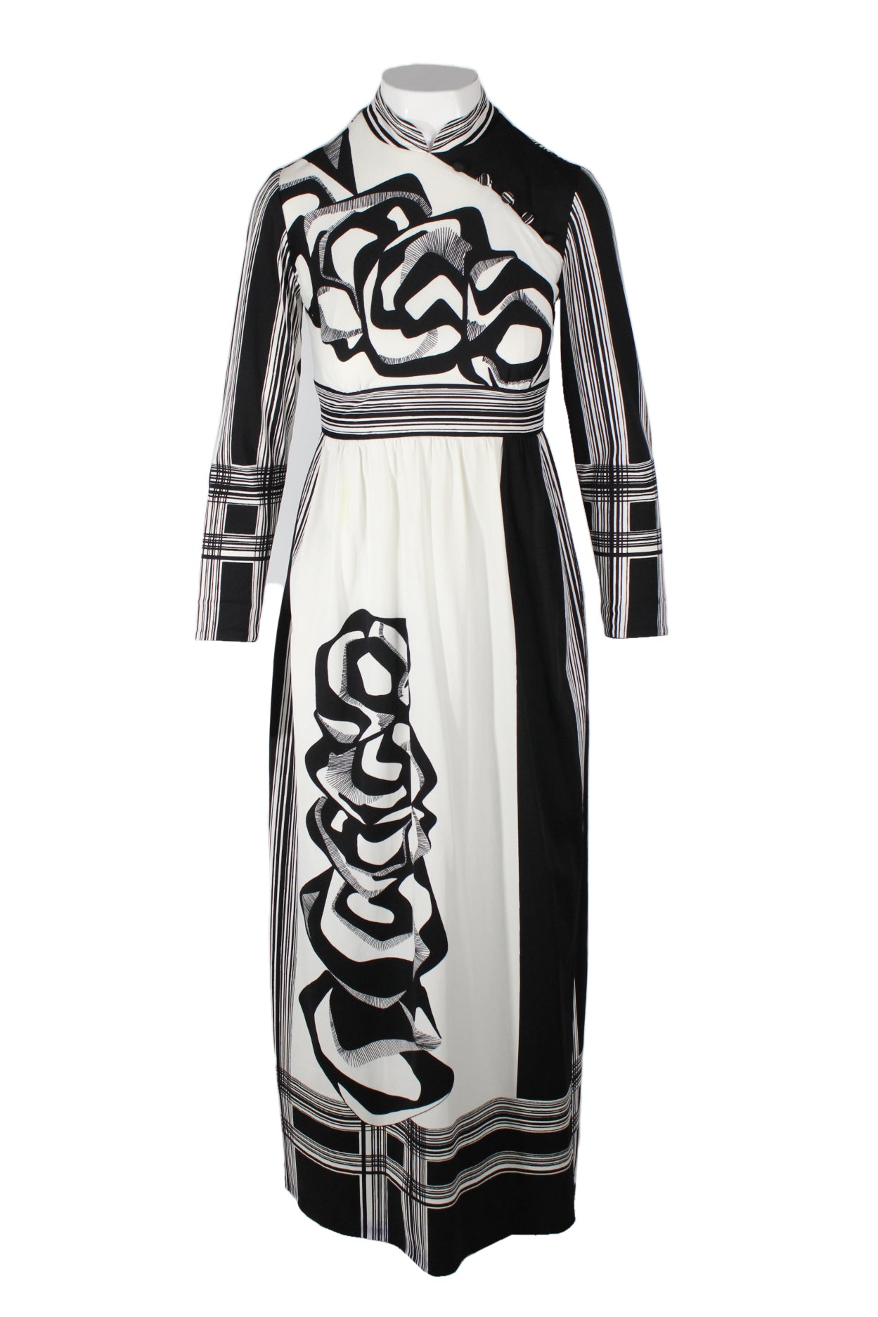 vintage 1970's black and white cheongsam. features geometric graphics framing curvelinear abstract designs. slit opening at knee length, internal lace trim detail, cheongsam beads across chest, and mandarin collar  
