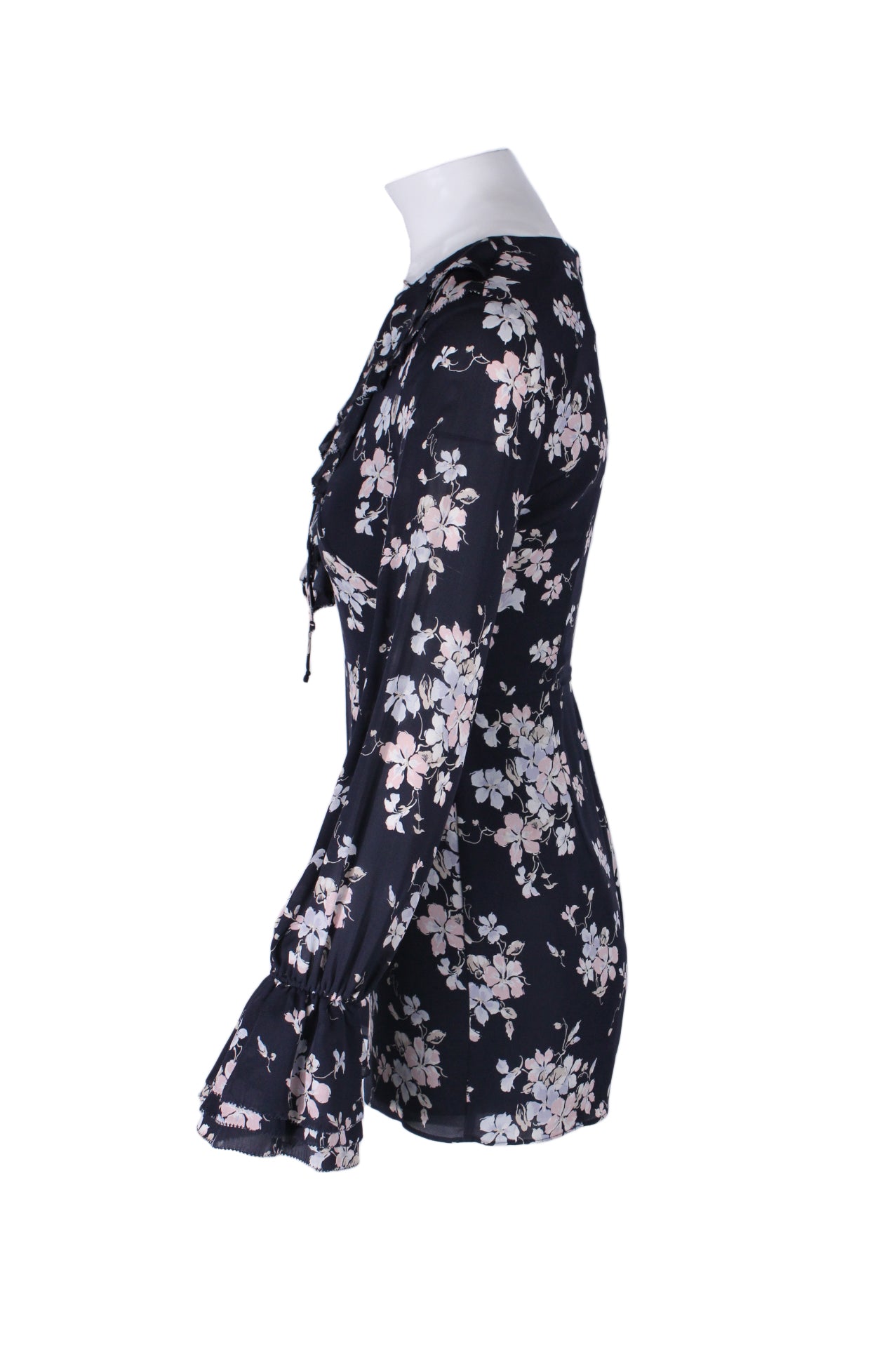 profile of overall with short length, and ruffled detail at cuffs.  