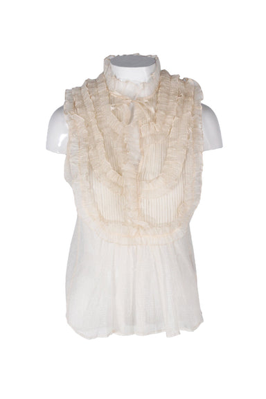 front angle stella nova blush semi-sheer sleeveless top on feminine mannequin torso featuring pintuck/ruffle embellishment and keyhole neckline.
