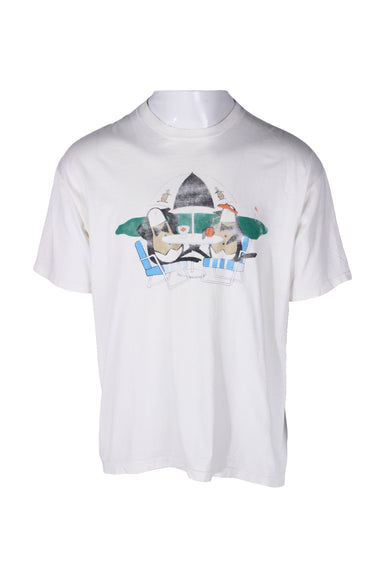 front angle of vintage grand slam white graphic t-shirt. features faded print of two penguins lounging at a golf course. single stitch hem/cuffs with ribbed rounded collar. 
