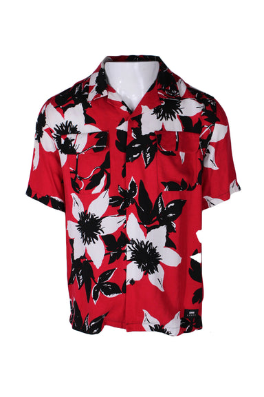 front angle of floral short sleeve button up shirt. features notched collar and two flap breast pockets. branded embroidered patch near left hip with text 'edwin'. 