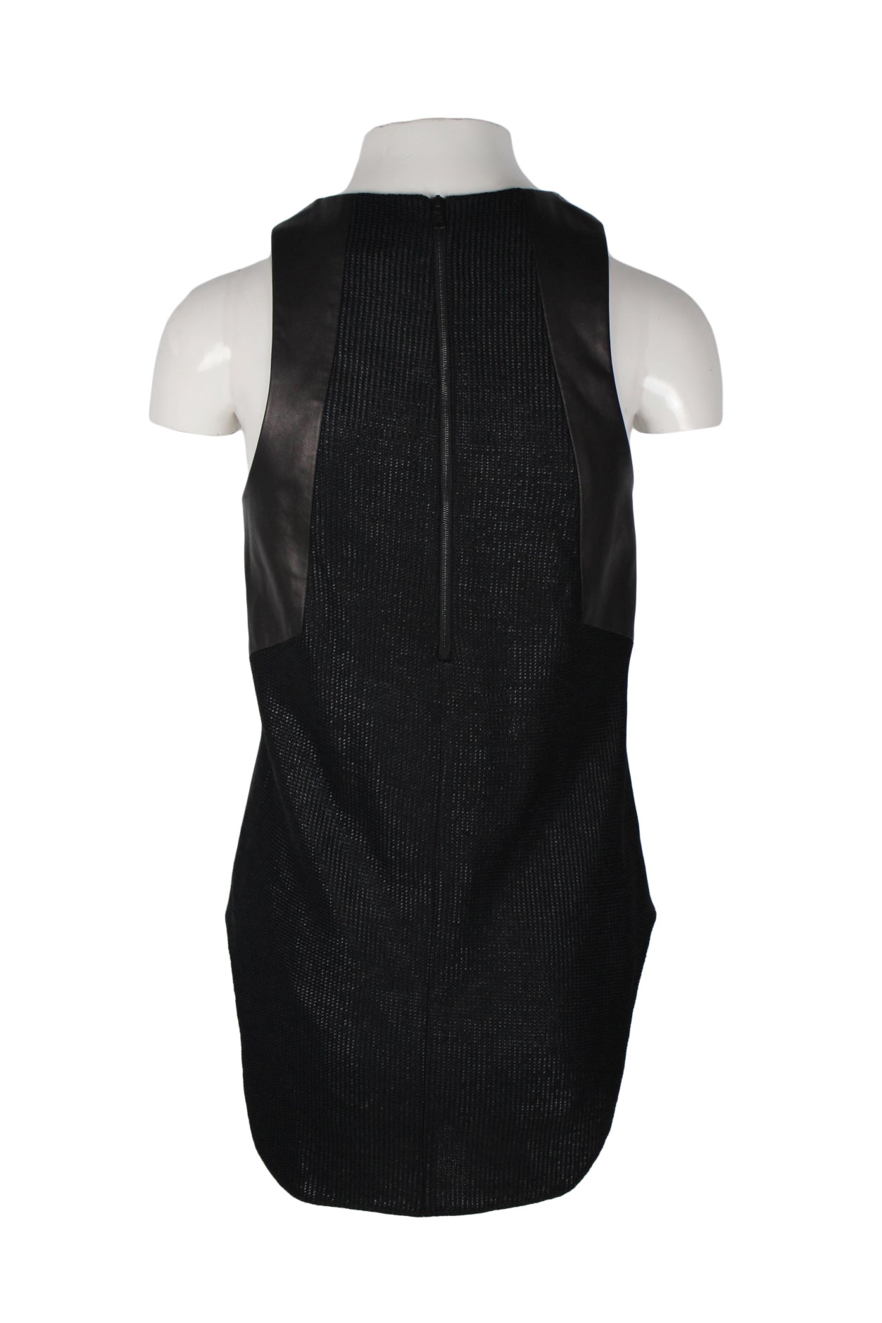 back angle of woven sleeveless blouse. features exposed dark zipper behind neck, low rounded hem, and leather panels on sides from shoulder to bottom of shoulder blade. 