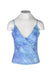 front angle of e.gen blue dyed sheer floral tank top on fem mannequin torso. features cross over v-neckline, opaque bust, spaghetti straps, and slight stretch to fabric. 