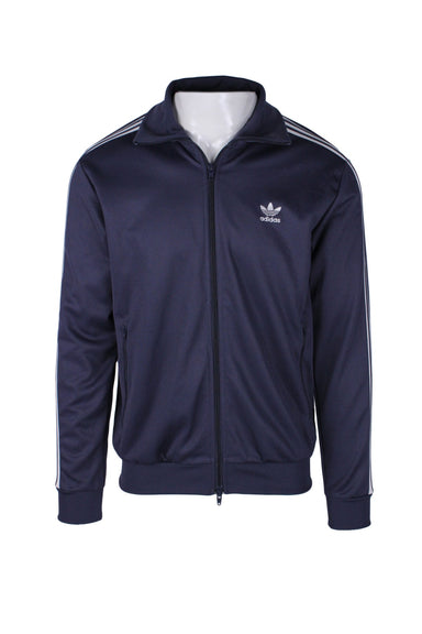 front angle adidas dark blue 'beckenbauer' primeblue track jacket on masculine mannequin torso featuring embroidered chest logo with 'adidas' text, vertical zip pockets, and 2-way front zip closure.
