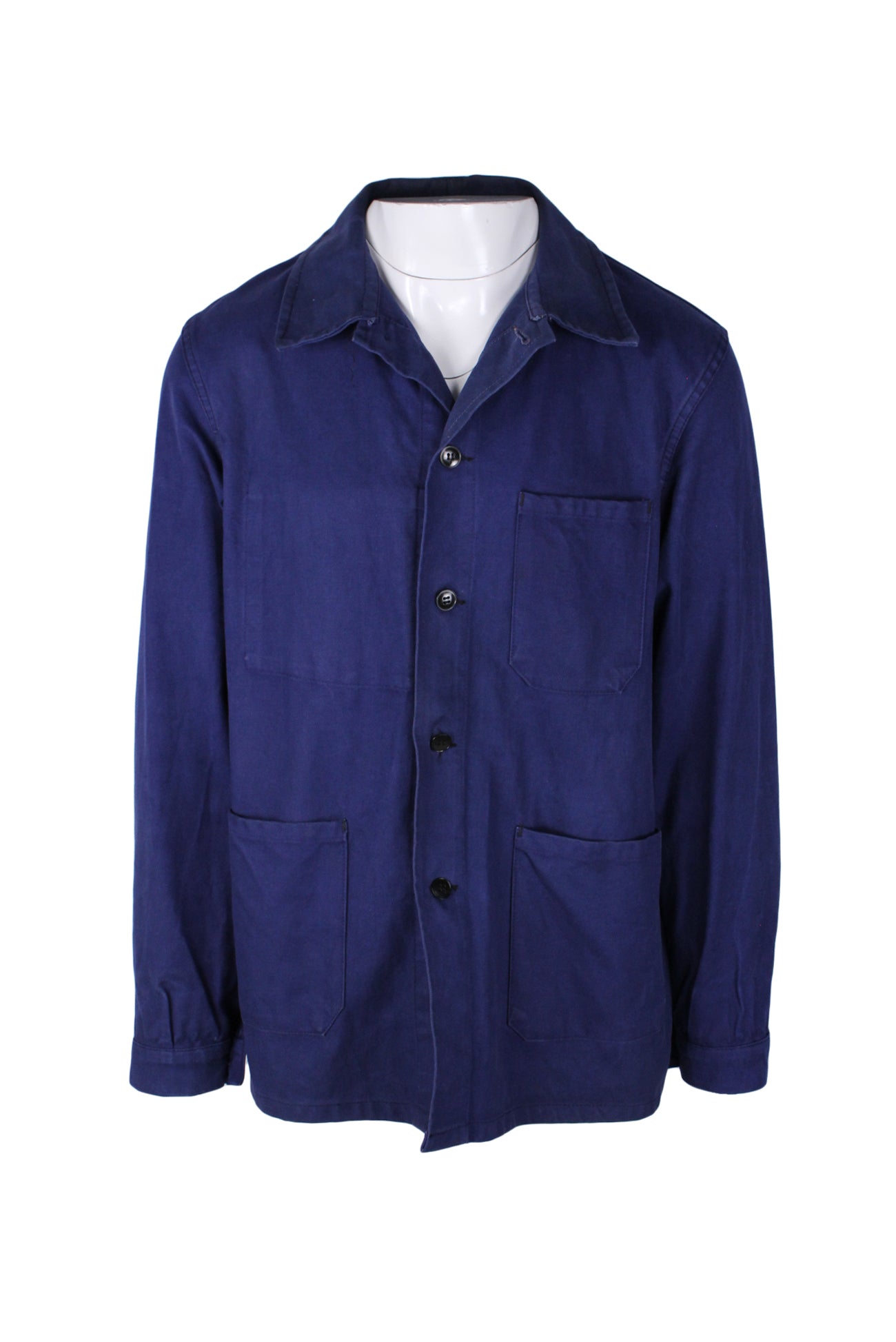 front angle of vintage le meilleur d'amiens deep blue chore jacket. features black button closure up center, three outer patch pockets, one inner pocket, pointed collar, and long sleeves with buttoned cuffs. 