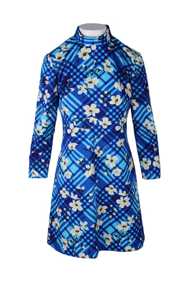 front of vintage blue long sleeve dress. features floral/checkered print throughout, turtle neckline, triangular stitching design at front, a-line style, and zip closure at back.