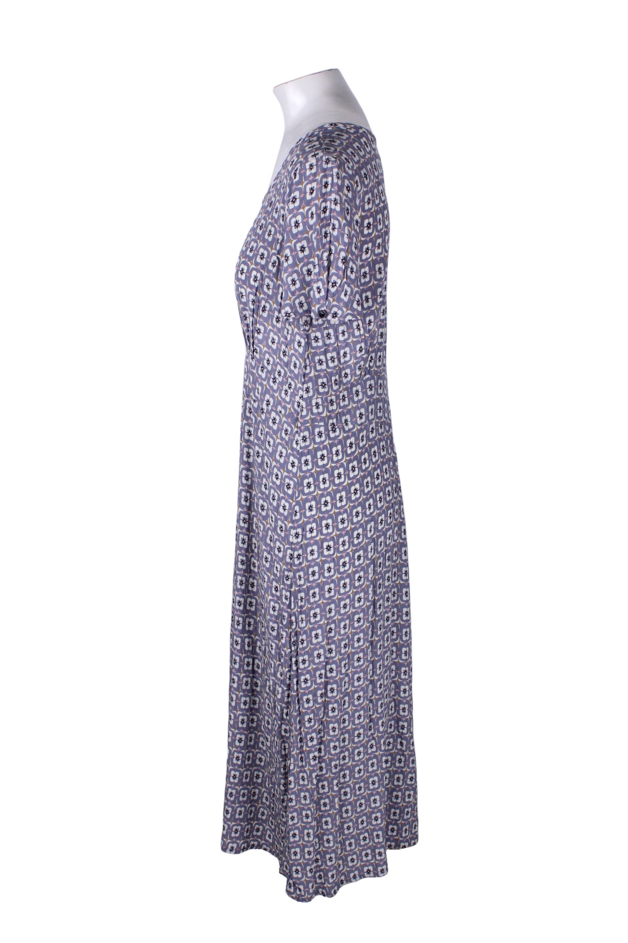 side view of flax light purple maxi dress. features rounded neckline, pink sparkle with repeating lilac and white print throughout, crinkled silk texture lasticized waist, and pull on style. 