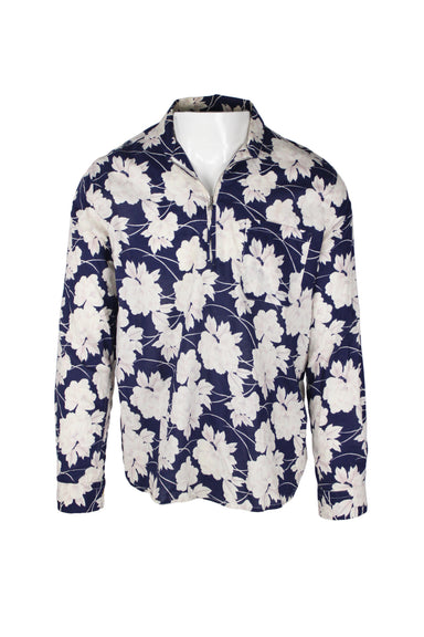 front angle of our legacy blue and white floral pull over shirt. features zippered half placket, low cut standing collar, light semi-sheer floral cotton fabric throughout, and single pocket over heart. 