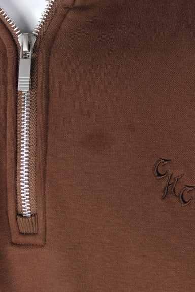 detail view of marks next to embroidered 'chc' logo of shirt.