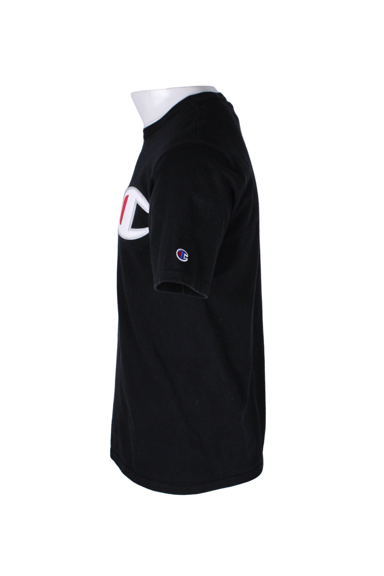 side angle champion black short sleeve t-shirt on masculine mannequin torso featuring oversized white/red embroidered logo patch at left chest and blue/red/white embroidered logo patch at left sleeve.