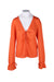 front of  free people orange long sleeve cardigan. features v neckline, double self tie at front, and adjustable drawstring at cuffs. 