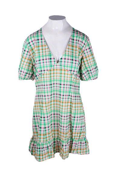 front of never fully dressed green plaid short sleeve dress. features v neckline, elastic at sleeves, and ruffled detail at hem.