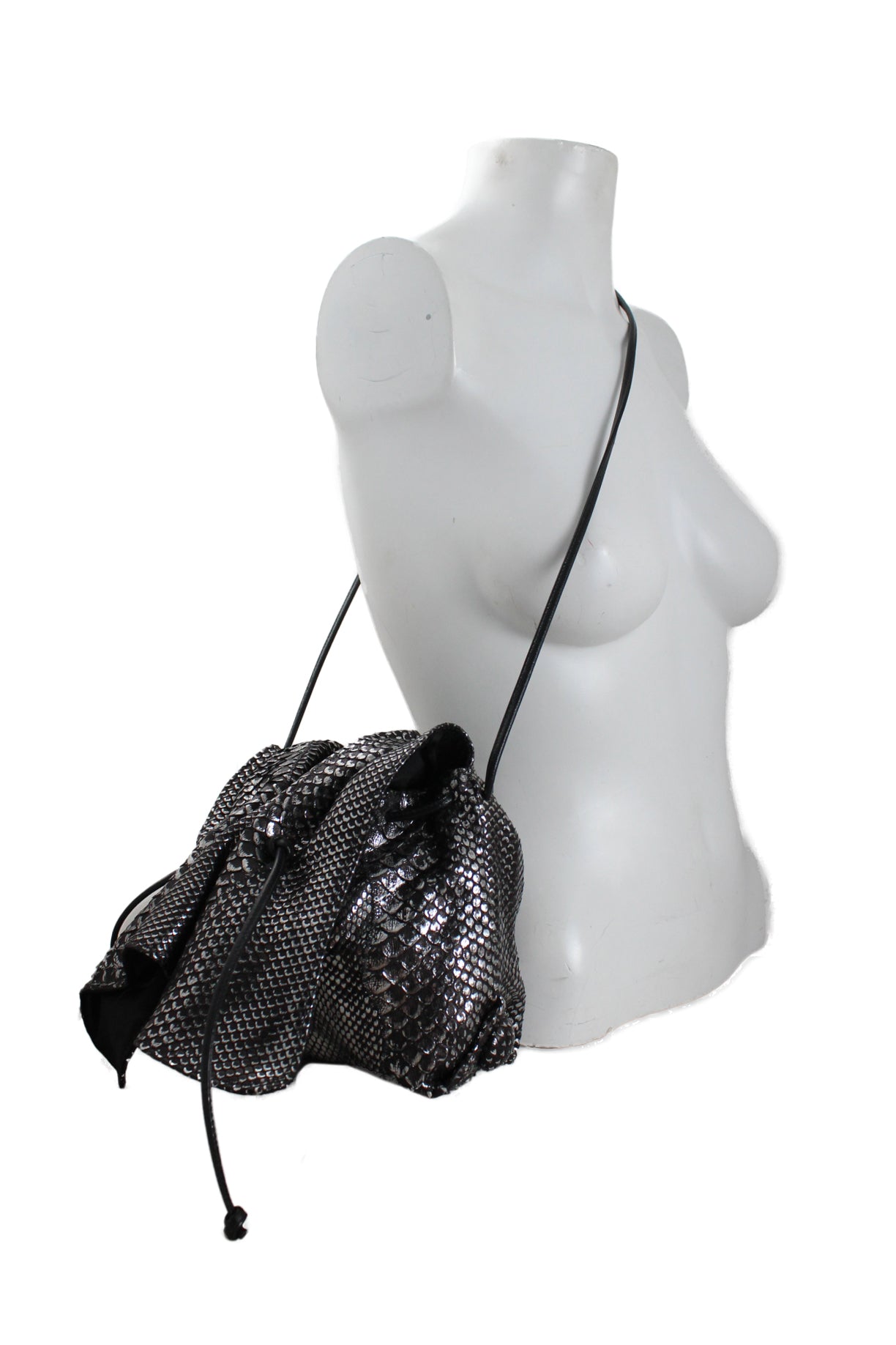 side view of carlos falchi black and silver flap top bag.