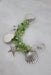 top view of the back of the bracelet laid flat showcasing the silver toned metallic sea-themed charms of starfish and shells.