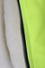 detail of zip closure and neon green lining. 