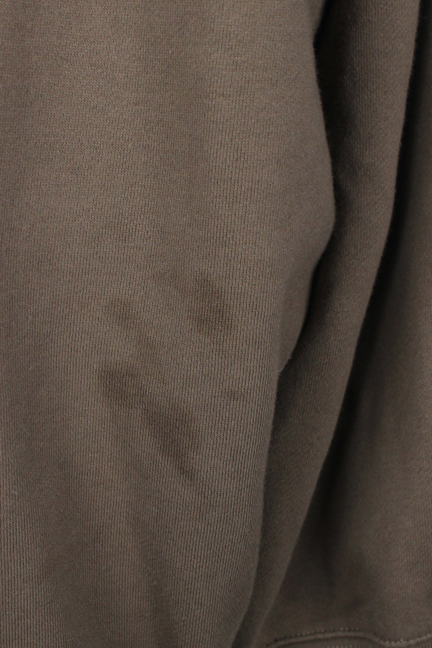detail view of marks at left elbow of sweatshirt.
