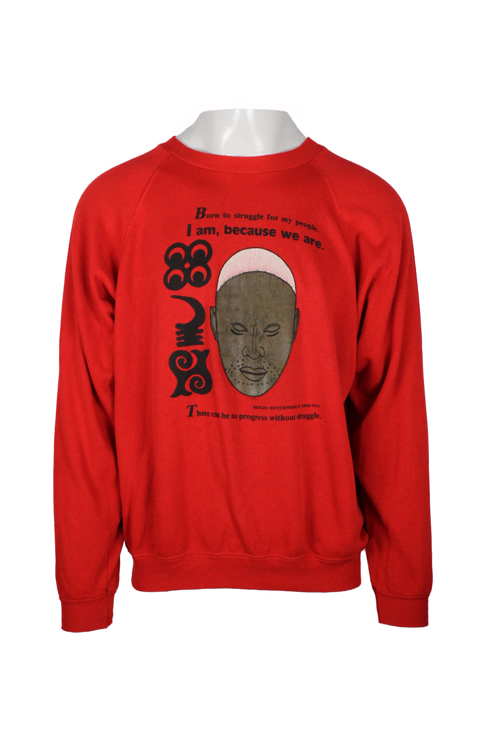 front view of vintage 80’s red hanes pullover sweatshirt. features ‘born to struggle for my people. i am, because we are. there can be no progress without struggle.’ graphic printed at front. ‘sekou enterprise co 1989 nyc.’ printed below graphic, and ribbed at collar/cuffs/hem.