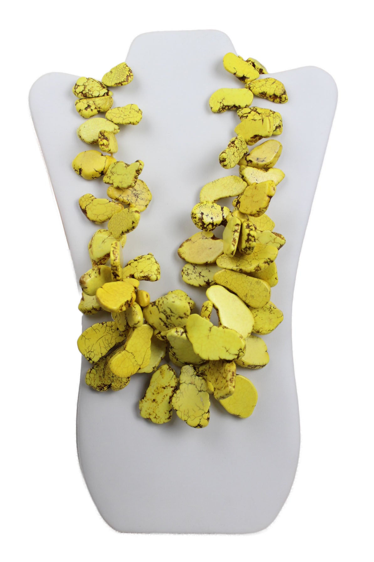 nest statement yellow turquoise necklace. features pieces with flat smooth sides of varying sizes attached with string and gold metal closure.