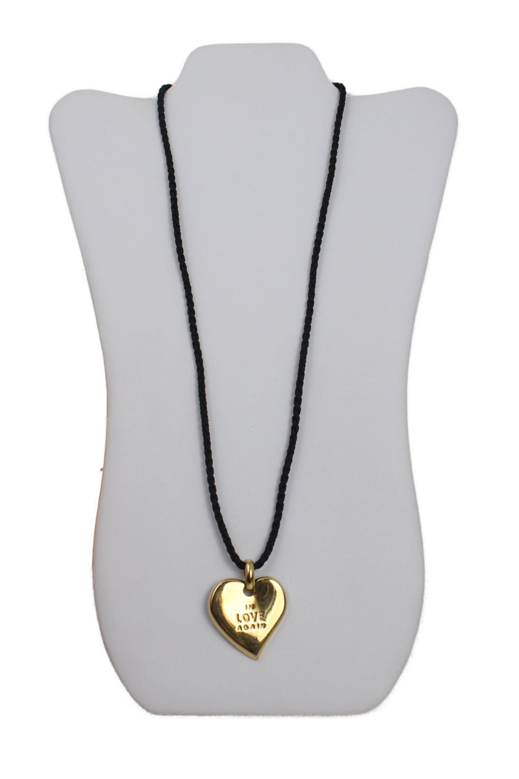 description: vintage yves saint laurent in love again gold-tone necklace pendant. features heart-shaped pendant with "in love again" embossed, black cord, lock closure at back, and signed at back. 