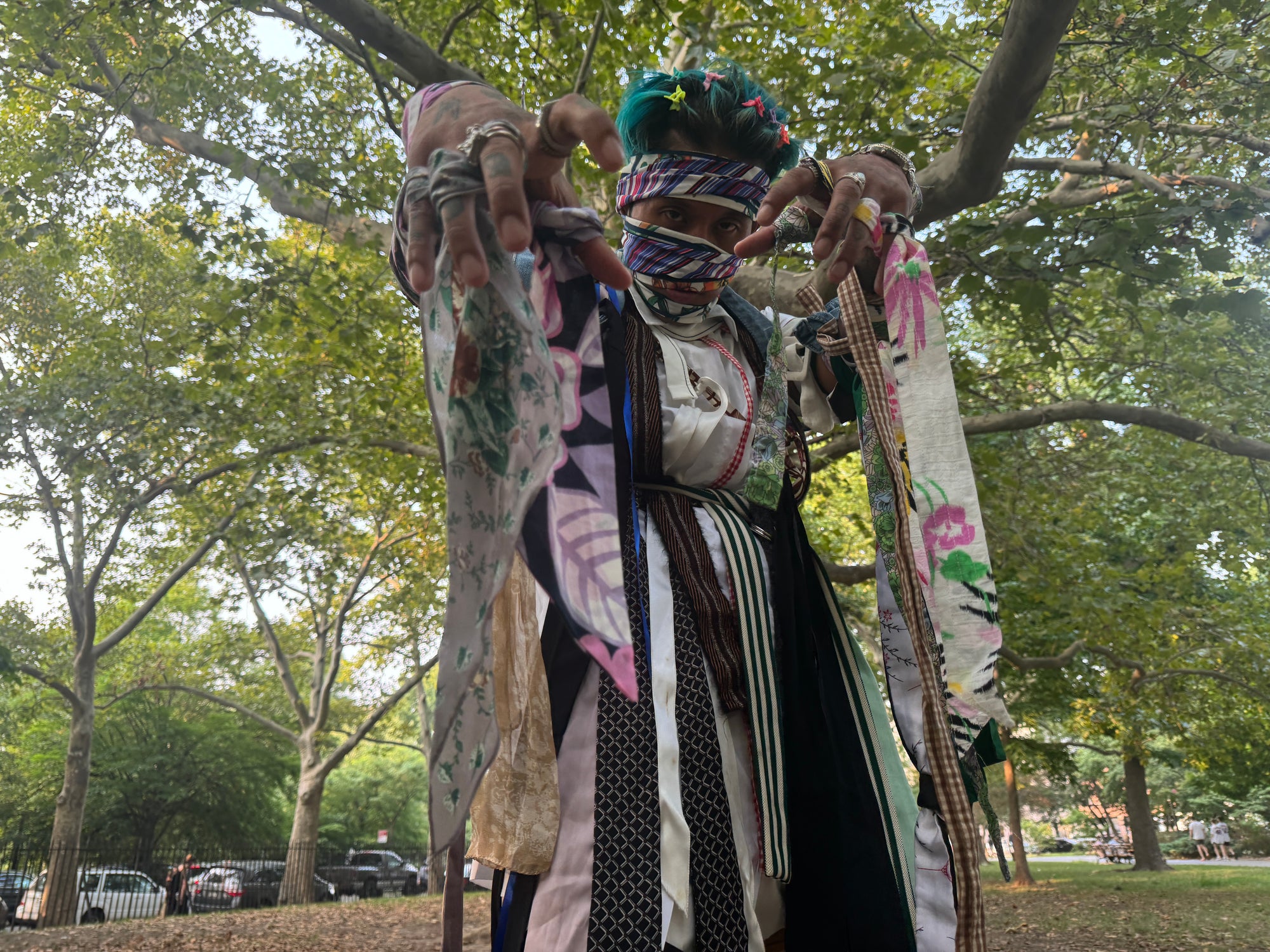 man in diy editorial mummy costume made completely from ties and old cloth belts