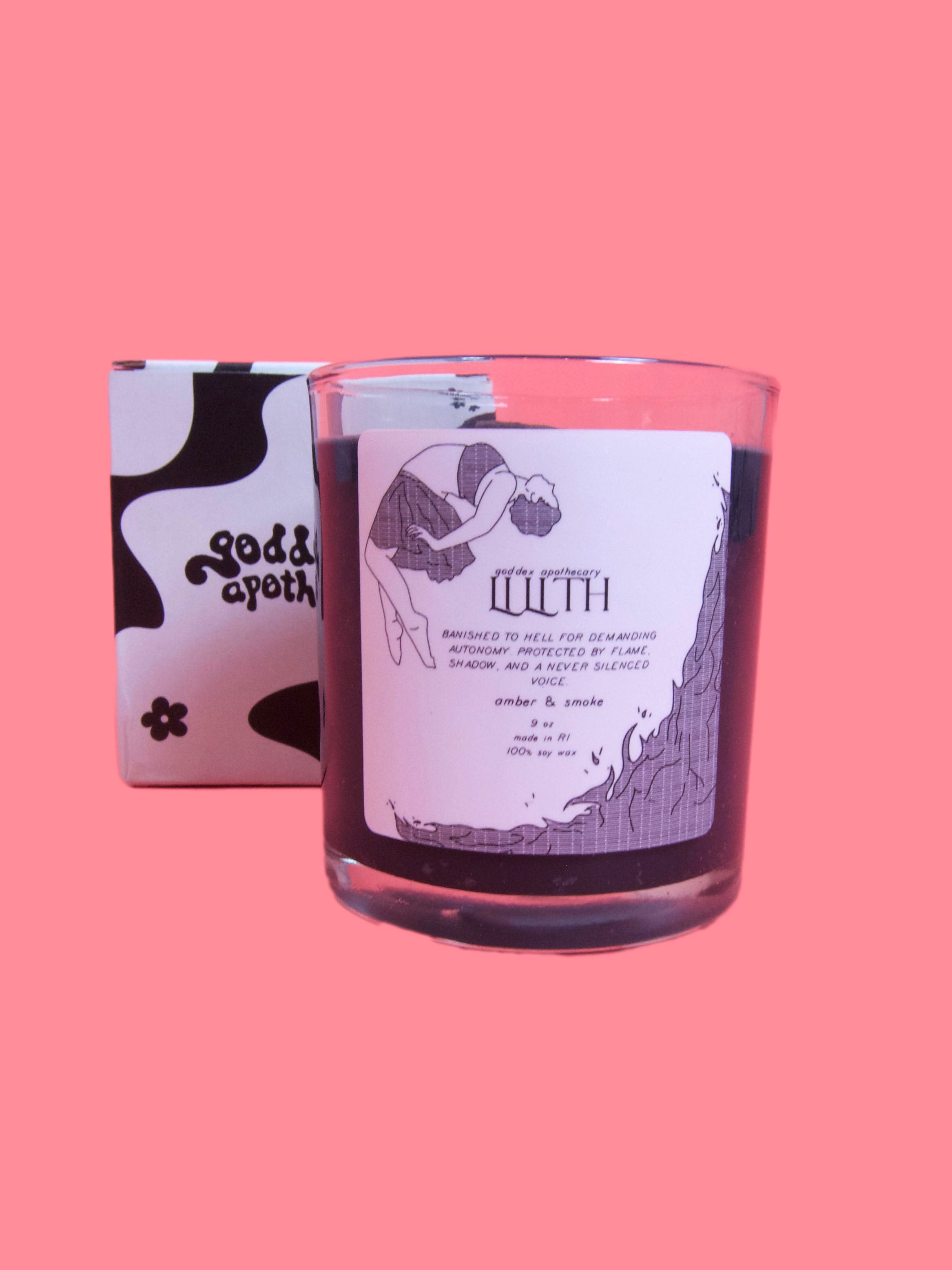 product shot of goddex apothecary lilith candle. label on candle reads: goddex apothecary, lilith: banished to hell for demanding autonomy protected by flame, shadow, and a never silenced voice. amber & smoke, 9 oz, made in rik, 100% soy wax