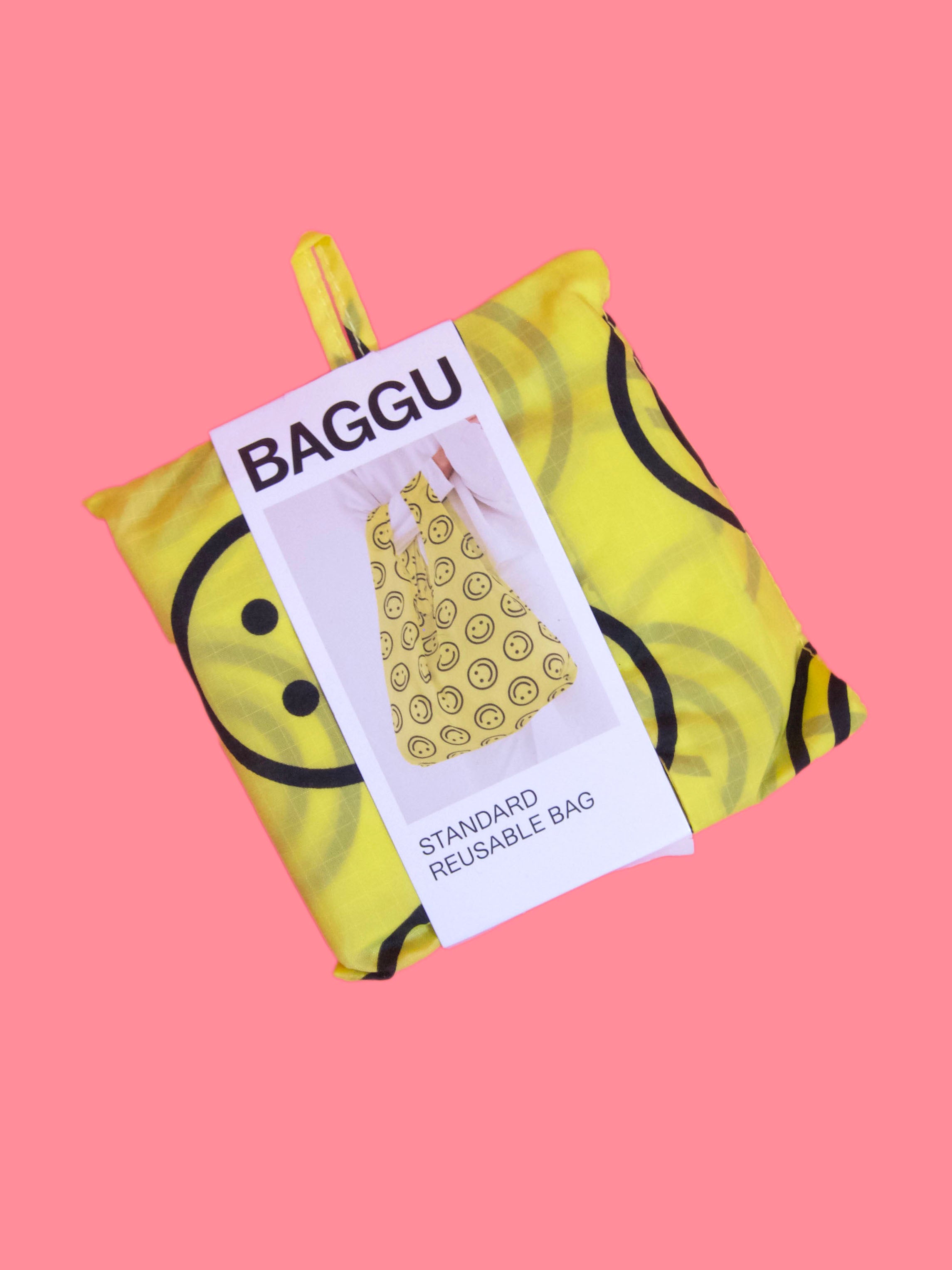 product shot of yellow happy print folded down baggu bag