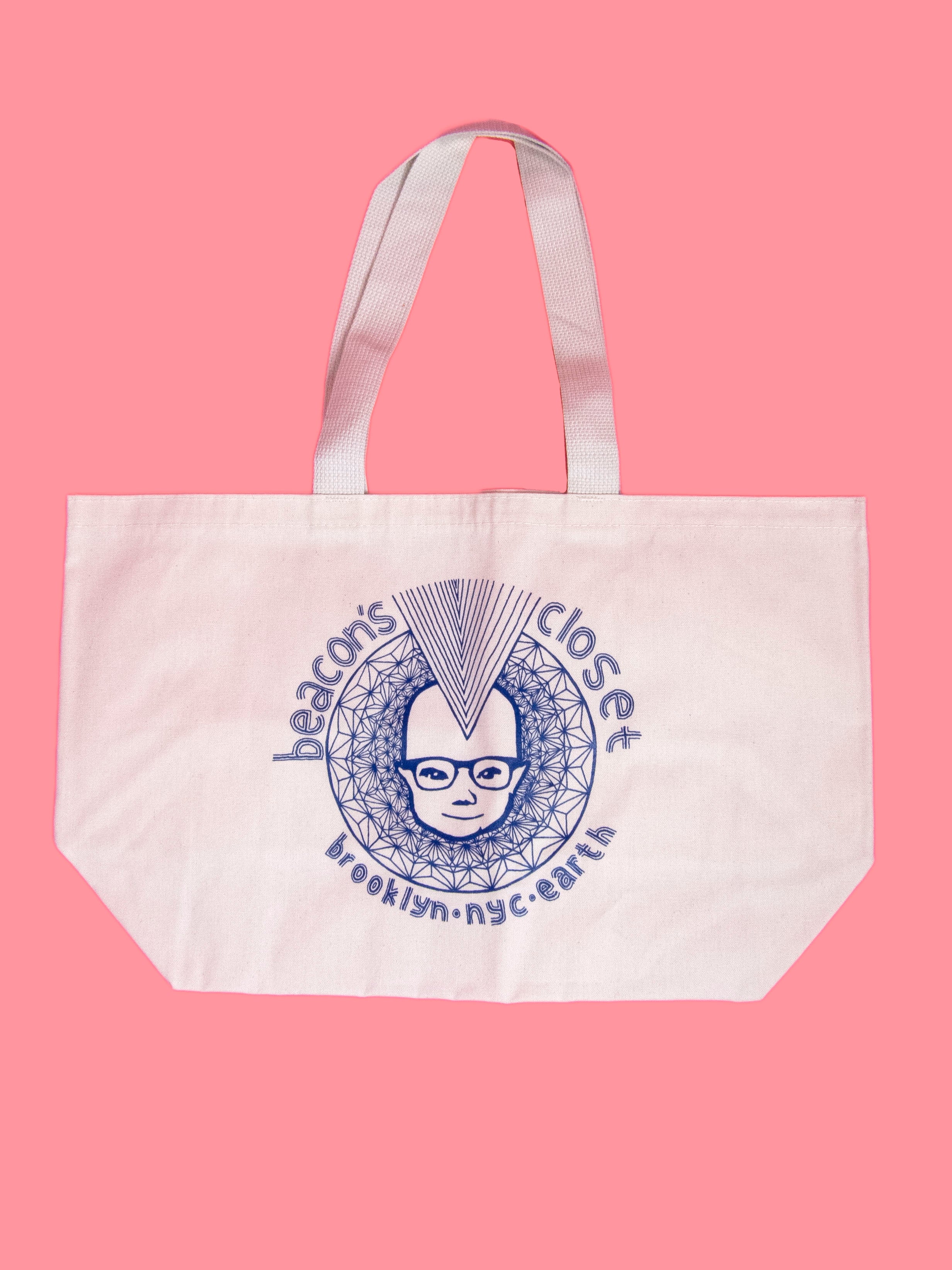 product shot of beacons canvas tote bag. branding graphic at front, reads; beacon's closet, brooklyn, nyc, earth