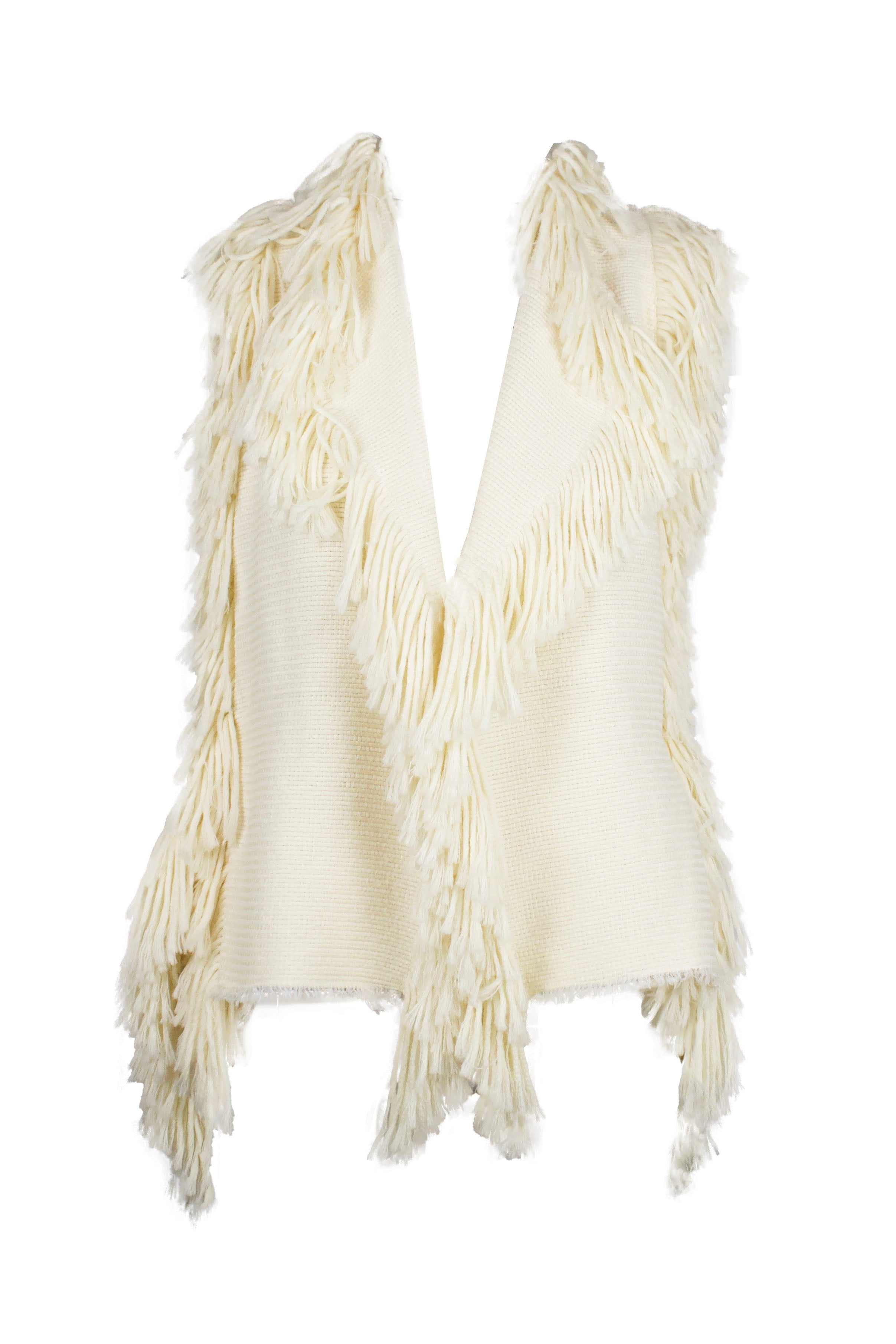 front of lanvin river 2005 beige knitted fringe vest. features fringe hem throughout center, shoulders, open back, and knitted fabric throughout. 