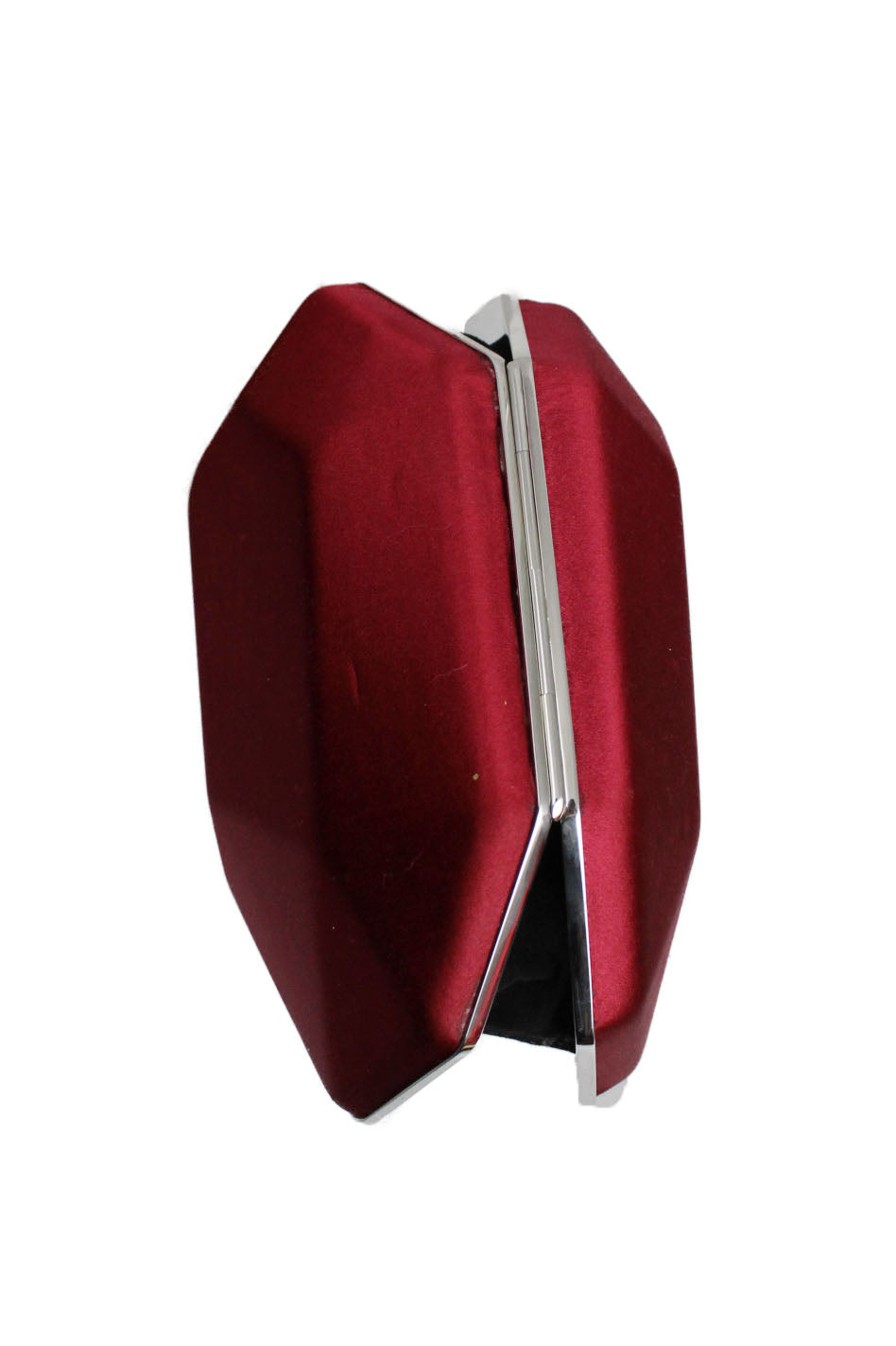 atelier swarvoski ss19 clutch. features asymmetrical geometric silhouette with red satin. silver trim and internal black fabric lining with small pocket. rhinestone on top acts as a closure release.