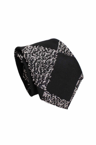 three-quarter angle rolled up the museum of modern art black and white stylized neck tie featuring diagonal rectangular pattern with tufted threading and wide silhouette.
