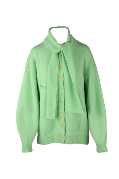 front of tibi green merino wool blend cardigan. features rounded neckline, self tie detail at neck,  ribbed trim, patch pockets at front, maxi button closure; oversized fit. 