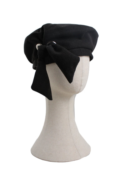 3.3 field trip black corduroy cap. features two silver grommets with attached bow, circular body, and full lining. 