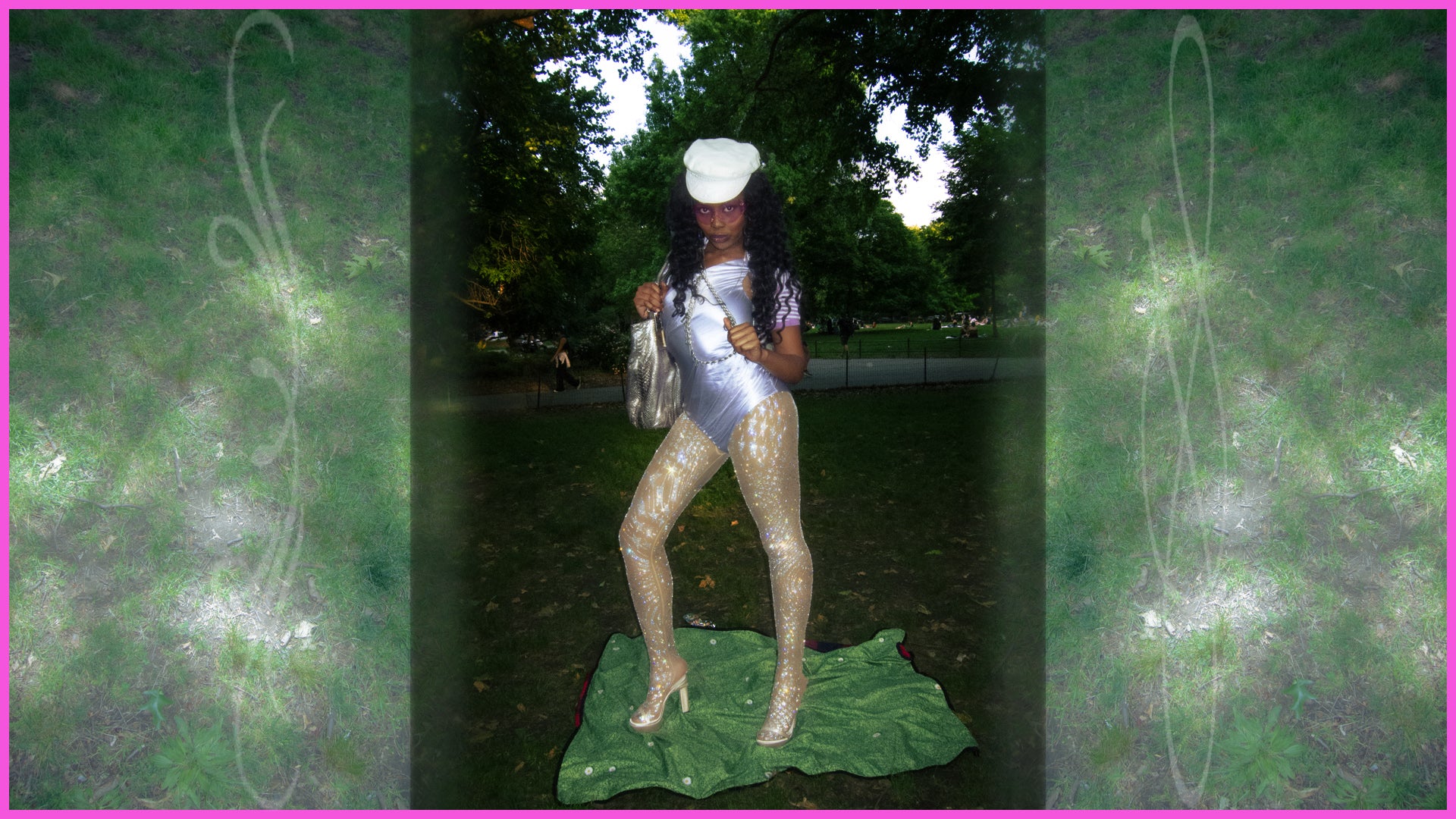 Person in a silver bodysuit standing on a large green leaf print blanket in an outdoor setting