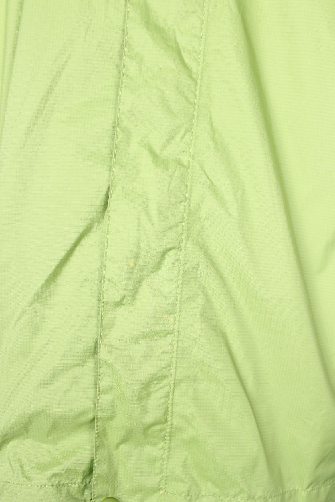 detail view of mark at placket of jacket.